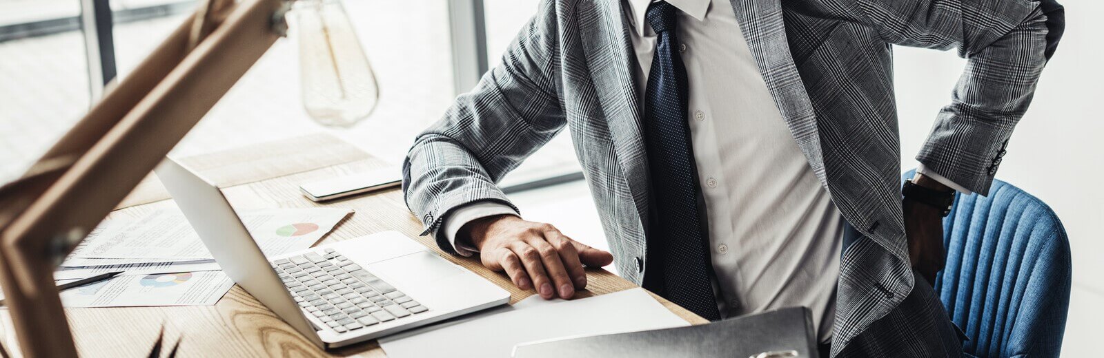 Man sitting at his desk with back pain