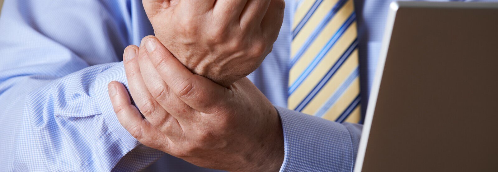 Man in office suffering from a wrist injury