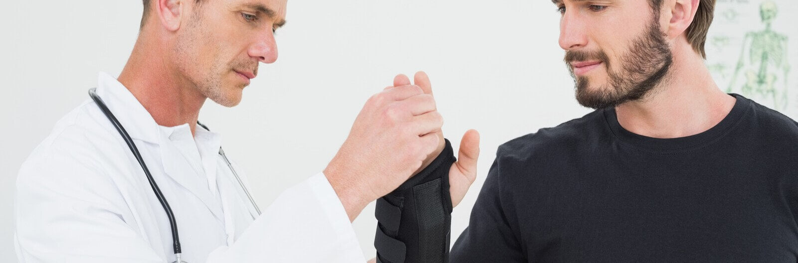 Man with his physiotherapist discussing wrist braces