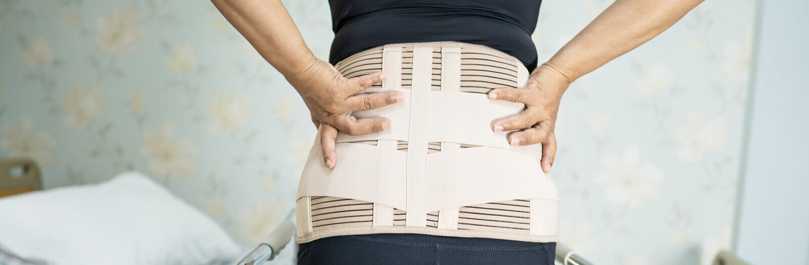 Woman wearing back brace at the hospital