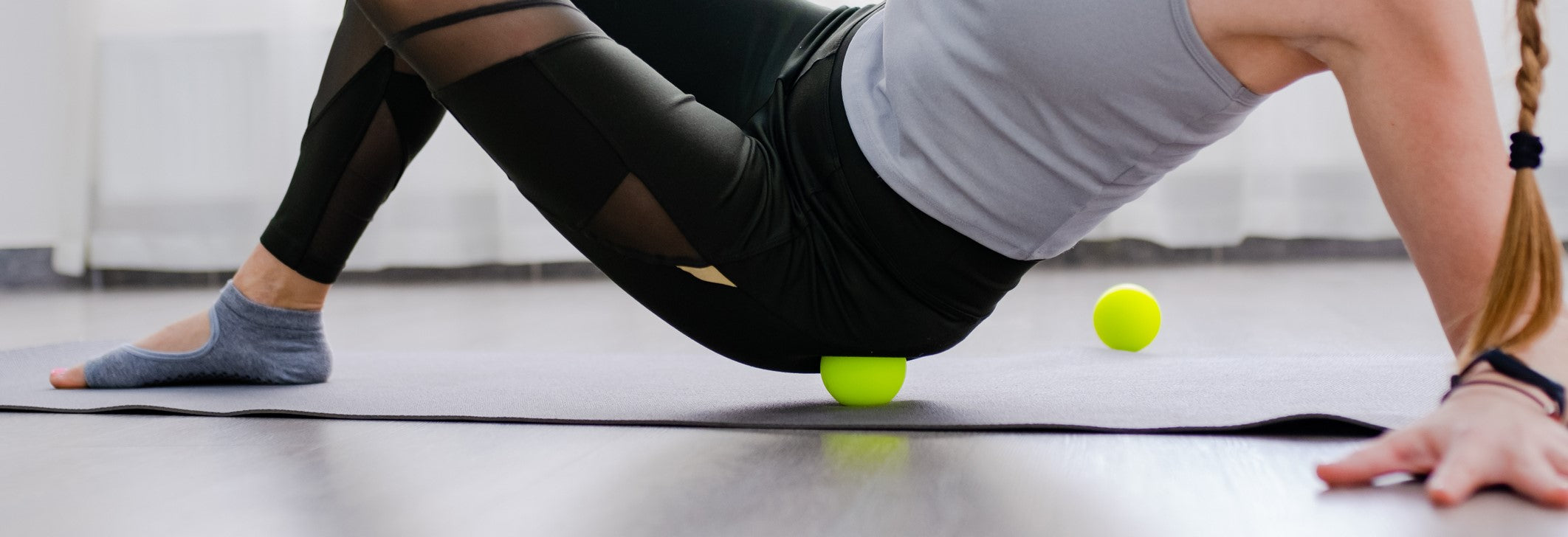 Young female using massage balls for therapy