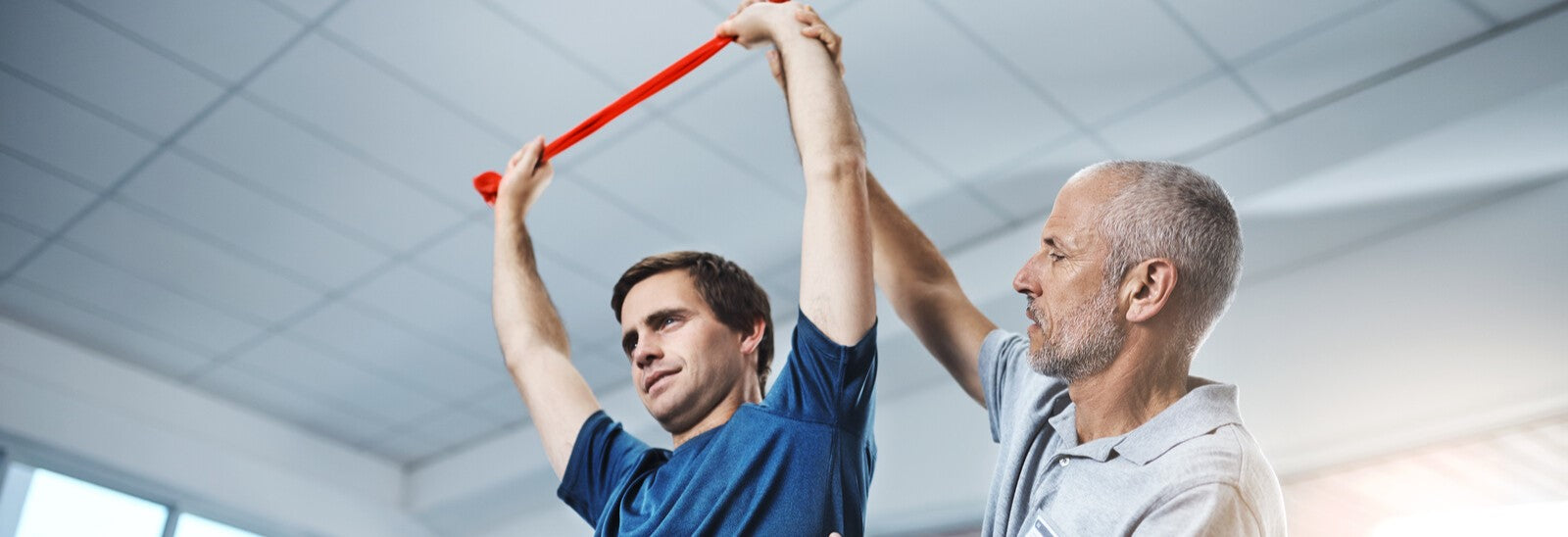 Physiotherapist helping man with rehabilitation