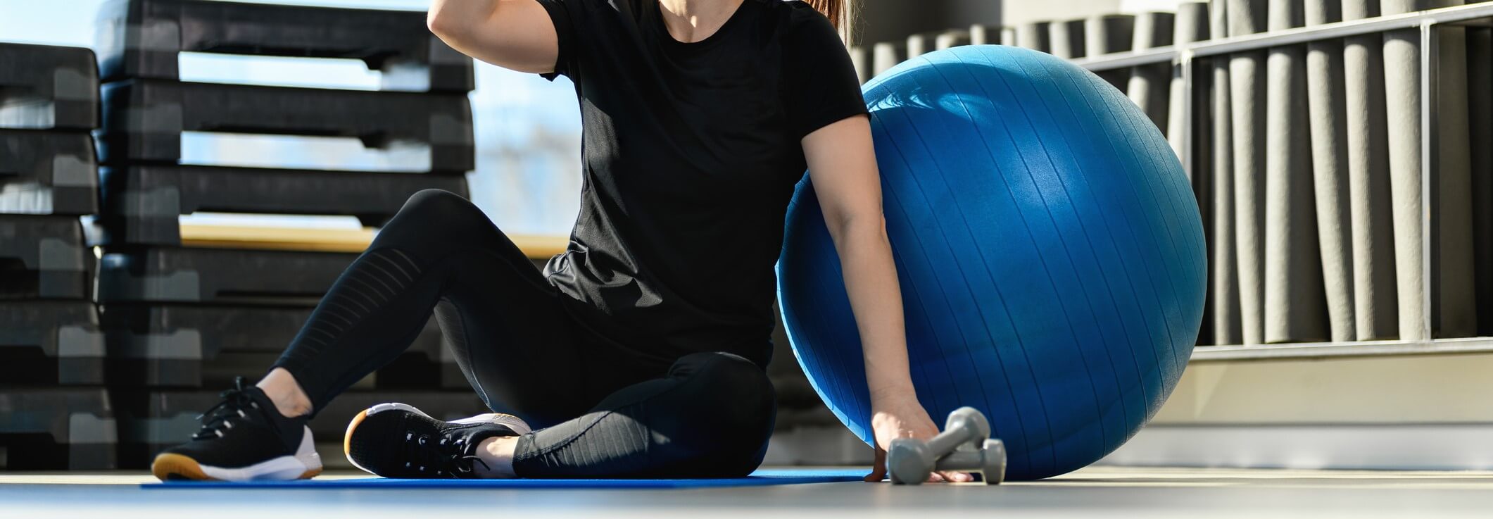 Woman taking a drink brink after using the exercise ball