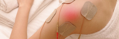 Young lady athlete patient receiving TENS and EMS therapy 