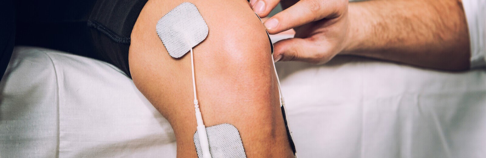 Man using TENS machines for treating musculoskeletal pain