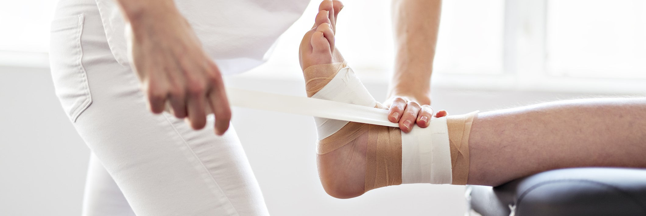 Ankle getting taped by physiotherapist because of ankle injury