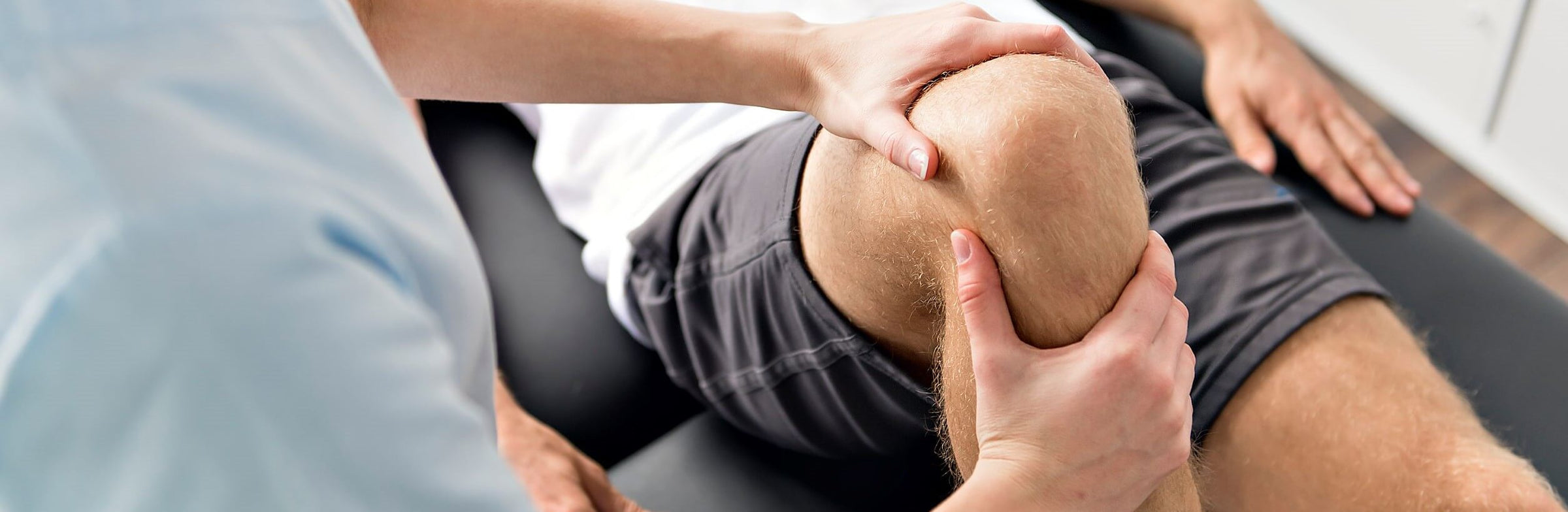 A man with possible PCL tear is getting knee checked by Physiotherapist