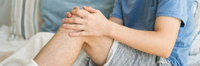 Young man on bed with his knee bursitis issue