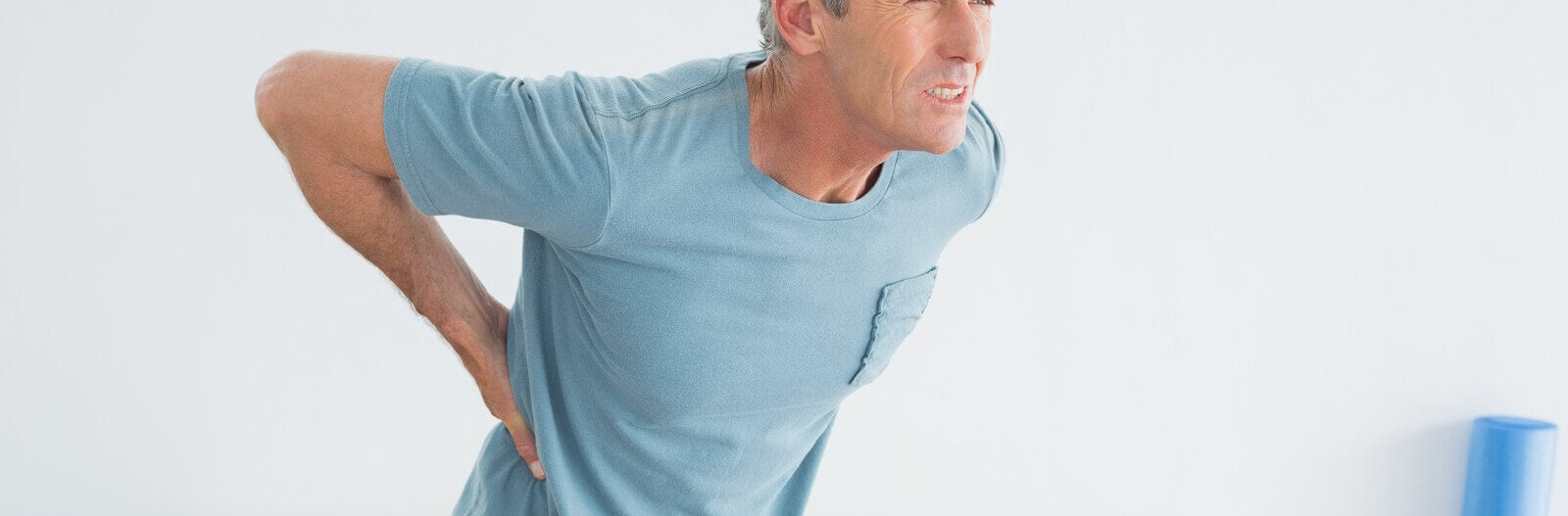 An older man experiencing a lower back pain