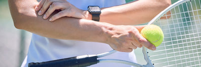 A female athlete suffering from a tennis elbow injury