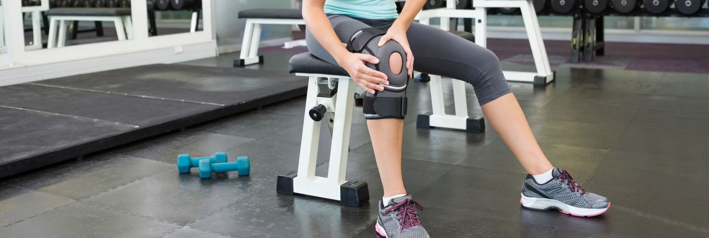 A woman in gym with her sports knee brace
