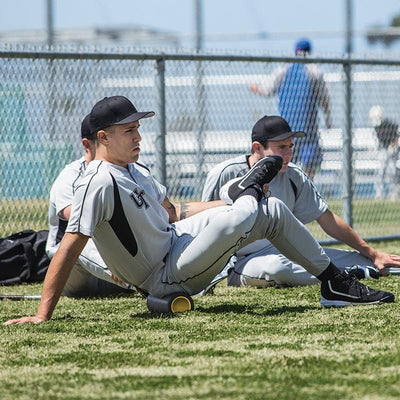 SKLZ Travel Barrel Roller in use - Man seated rolling on Barrel